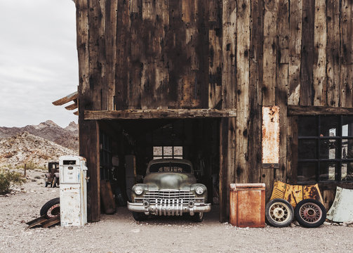 Old vintage rusty car truck abandoned in the abandoned gas station.