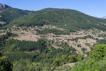 Fototapeta na wymiar View of a valley with rural houses in the mountains of Montenegro 