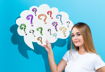 Question marks with young woman holding a speech bubble