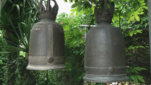 close up of large bronze bells at phu khao thong, golden mount, a part of wat saket temple in bangkok, thailand