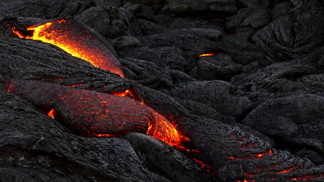 a close up tilt down shot of a surface lava flow from kilauea volcano on the big island of hawaii in the united states of america