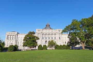 The Library of Congress building in Washington DC, USA. Library building with fine decorations, murals, columns and steps located across the green lawn from the Capitol.