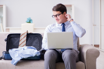 Businessman preparing packing for business trip