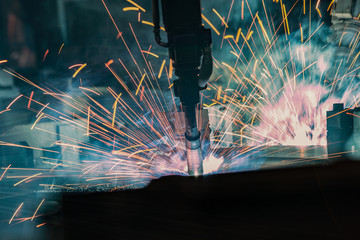 Industrial robots are welding in factory