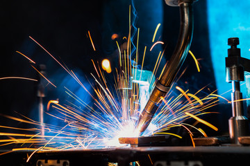 Industrial robot is welding in factory