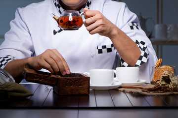 Tea expert brewing cup of drink