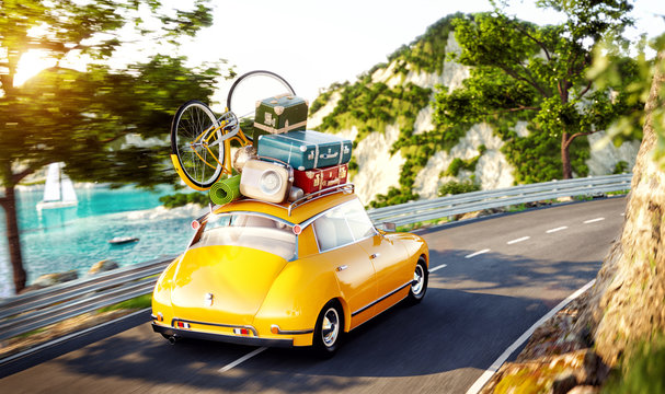 Cute little retro car with suitcases and bicycle on top goes by the road along beautiful harbor between mountain in summer day.
