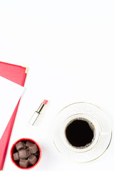 Coffee cup, sweets, lipstick on white background. Women's Day concept flat lay.