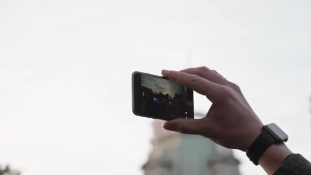 Unrecognizable hands taking photo or recording video of live music concert with smartphone outdoors. Photography, entertainment and technology concept