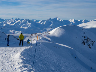 Mountain ski resort Meribel - nature and sport background. Skiers are going to go down on the mountains. France, January, 2018