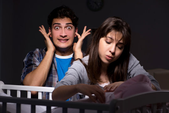 Young parents sleepless with newborn baby at night
