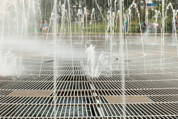 Water from a fountain in the park as a background