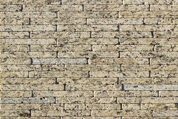 Fragment of a wall made of stone. Stone wall.