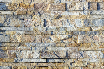 Fragment of a wall made of stone. Stone wall.