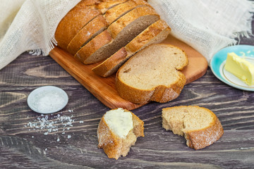 Still life with slices of bread on a wooden background
