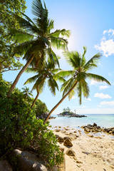 Tropical beach Anse Royale with granite boulders in the foreground at Mahe island, Seychelles - vacation background.