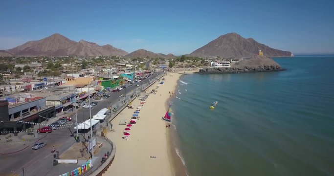 Aerial over the beach and malecon towards the lighthouse in San Felipe, Mexico, Baja California.