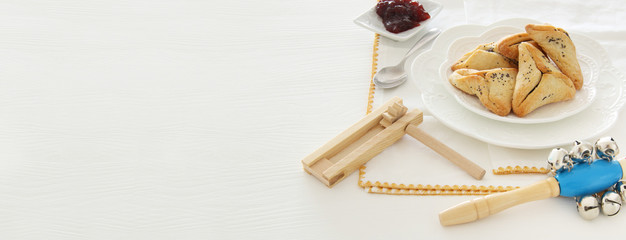 Purim celebration concept (jewish carnival holiday). Traditional hamantaschen cookies over white table.