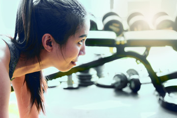 Sports girl tired  after exercises in a gym.