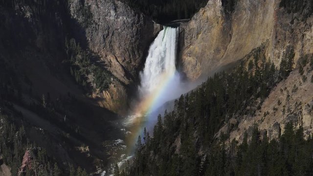 180p slow motion shot of lower yellowstone falls with a rainbow in yellowstone national park, usa