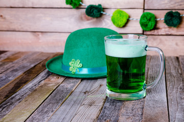 Mug of green beer with Irish festive hat