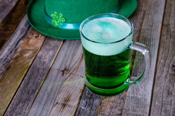 Mug of green beer with Irish festive hat