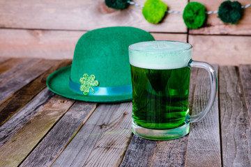 Mug of green beer with Irish festive hat