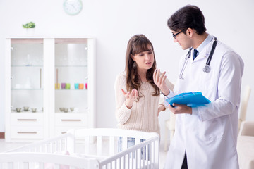Doctor explaining to young mother 