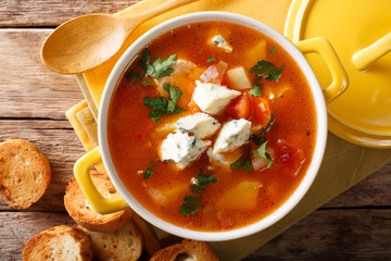 Delicious chicken buffalo soup with tomatoes, celery, carrots and blue cheese close-up in a saucepan. horizontal top view