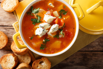 buffalo soup with chicken, vegetables and blue cheese closeup in the pan and toasted bread. horizontal top view
