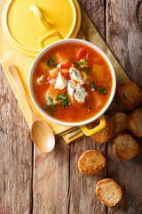 Chicken buffalo soup with vegetables and blue cheese close-up in a saucepan. vertical top view
