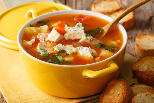 Chicken buffalo soup with vegetables and blue cheese close-up in a saucepan. horizontal