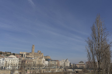 Lleida skyline blue plain river on a cityscape and blue sunny sky