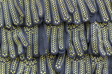 Background of black and yellow protective gloves