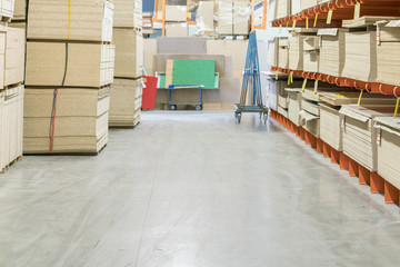 fiberboard and chipboard sheets on shelves in the building materials store.