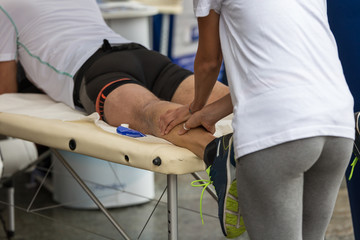 Athlete's Calf Muscles Massage after Sport Workout