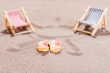 Two colorful sun loungers on the sandy beach