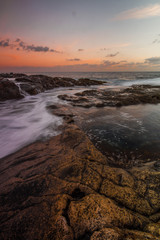 Fototapeta na wymiar Long Exposure sunrise, colorful sky, volcanic rock beautiful seascape at Gran Canaria Island Coast in Spain.