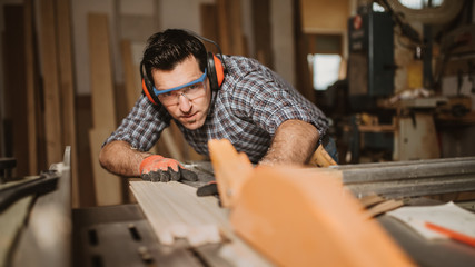 carpenter works with manual and electric equipment