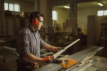 carpenter works with manual and electric equipment