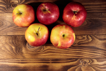 Red apples on wooden table. Top view, copy space