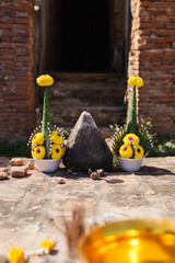 Religious offerings at a historic temple in Ayutthaya, Thailand