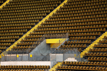 Fototapeta premium Yellow seats on the tribune of the soccer stadium