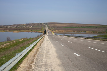 Summer asphalt road near the lake.