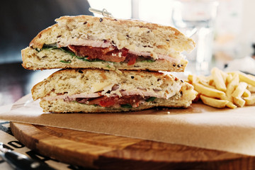 Sandwich on wooden plate.