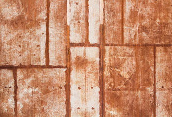 Old rusty metal wall with welded seams