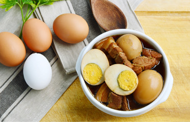 Eggs Stewed or Thai name is khai phalo muu saam chan on wooden background