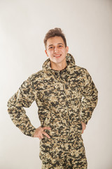Young guy in military uniform in camouflage