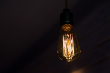 Close up glowing light bulb, Spiral lamp close up abstract blurred background