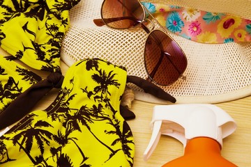 summer accessories, summer hat, sunglasses, bikini and suntan lotion
